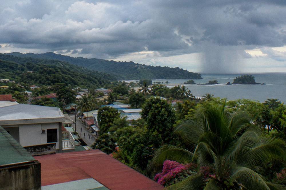 Dramatic green-season clouds over rainforest ridges above the coast