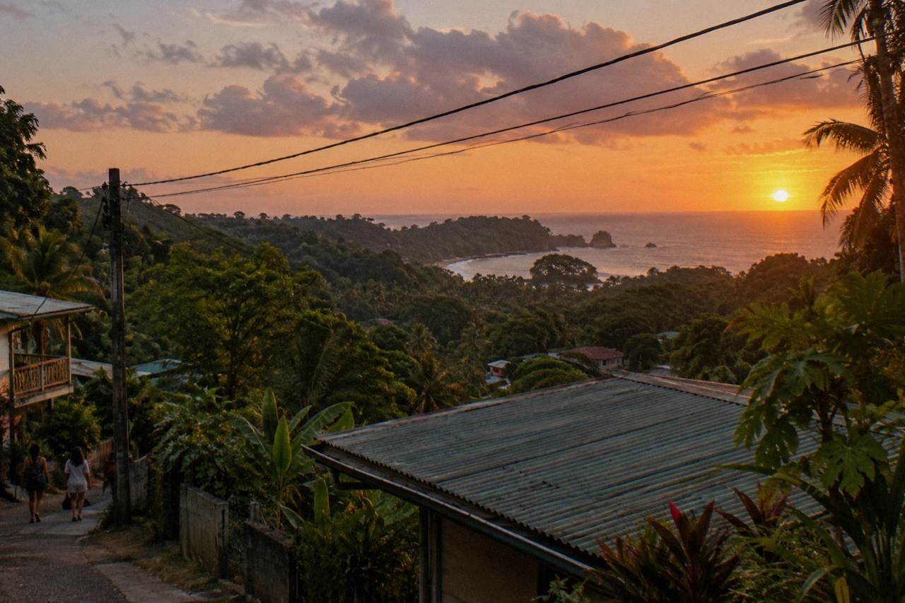 Sunset over the coastline near Manuel Antonio with forested hills meeting the ocean