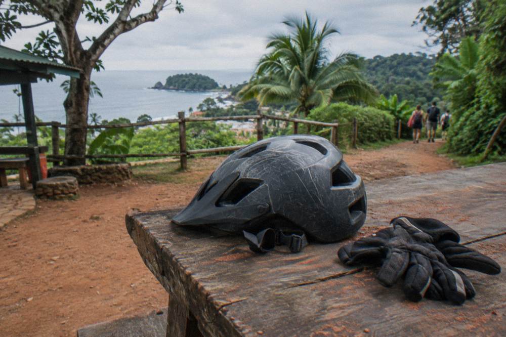 Riding gear, boots and a helmet arranged on a wooden bench before a tour