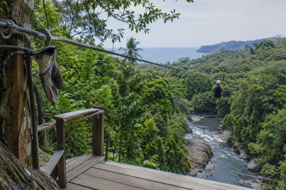 Zip line platform high in the rainforest canopy with cables stretching between trees