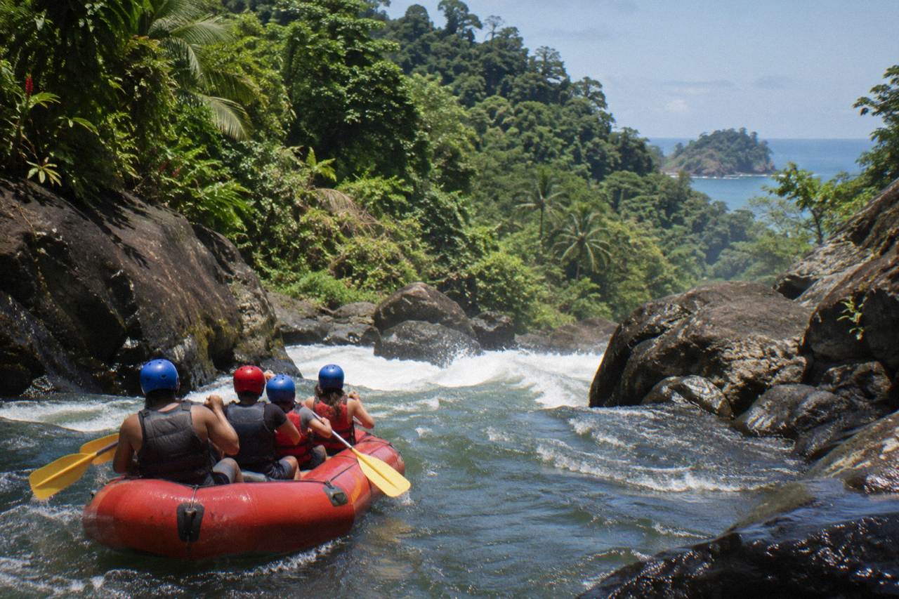 Raft floating through green jungle canyon on a Pacific slope river