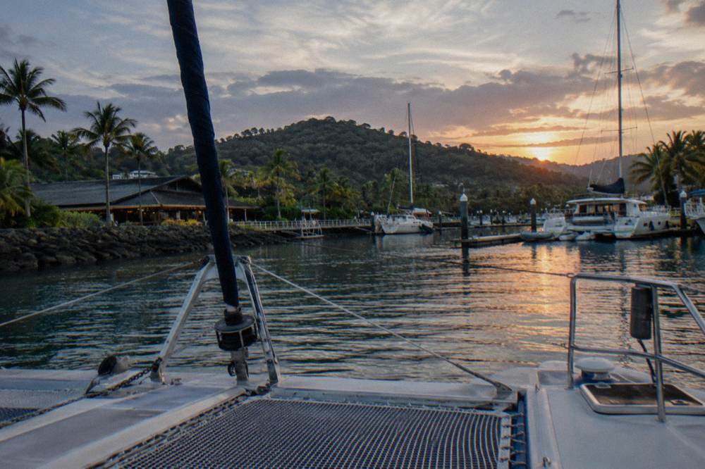 Dry bag and towel resting on a boat bench beside snorkel gear