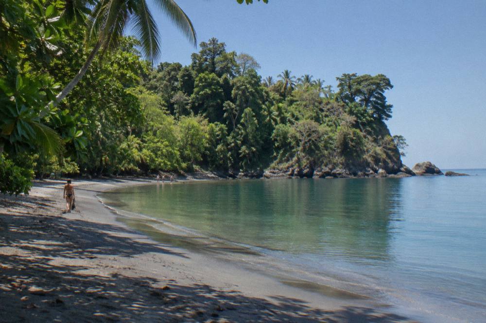 Dry season beach scene with clear sky and calm Pacific water along the Manuel Antonio coast