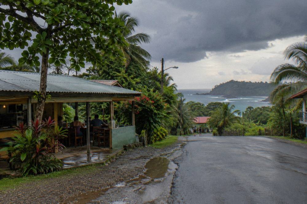 Rain clouds gathering over rainforest hills above the coast in the late afternoon